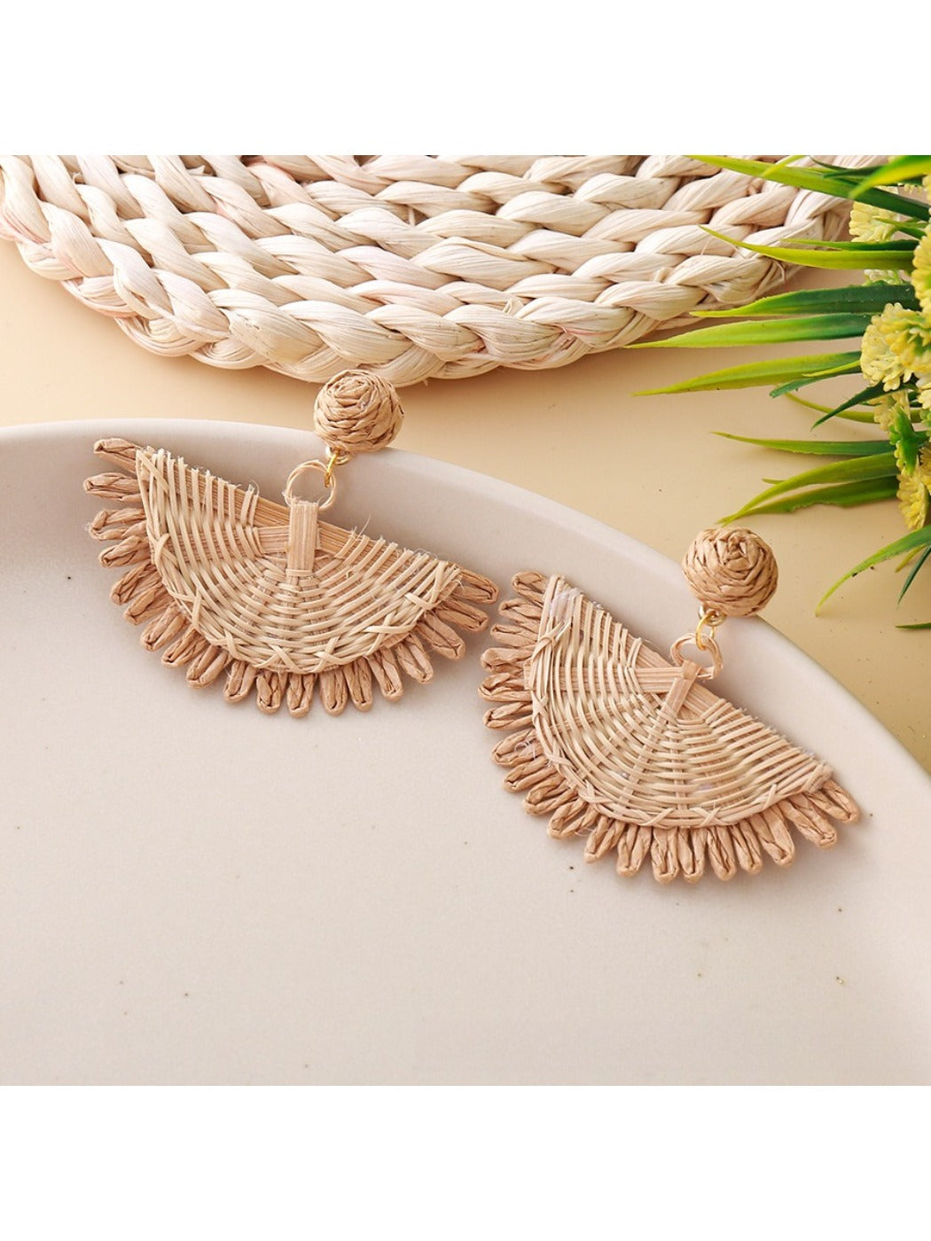 Model wearing Earedge raffia fan shaped drop earrings with casual outfit