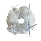Blue tulle ribbon bow scrunchie laid flat highlighting bow shape and fabric