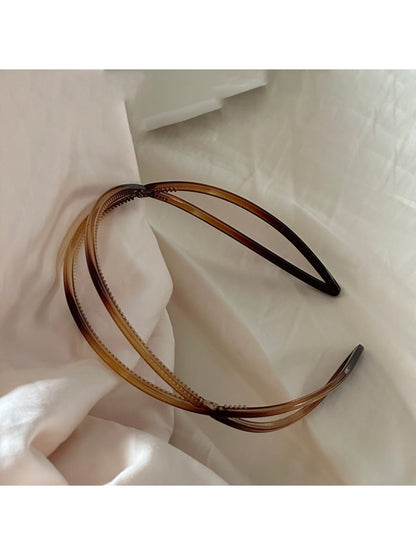 Gifty irregular acrylic headband displayed on wooden surface with soft lighting