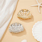 Beau ocean themed hair clip shaped like a seashell with blue and white accents