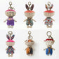 Back view of Keypus fabric doll bag charm highlighting fabric texture and tag