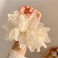 Close-up of white double layer scrunchie showing fabric texture and layers