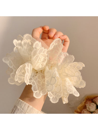 Close-up of white double layer scrunchie showing fabric texture and layers