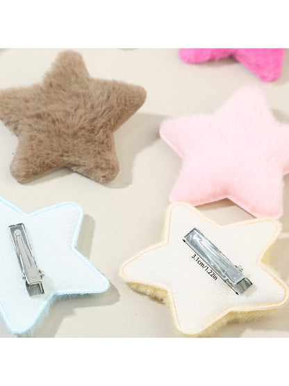 Beau star hair clip attached to a model's dark brown hair from side view