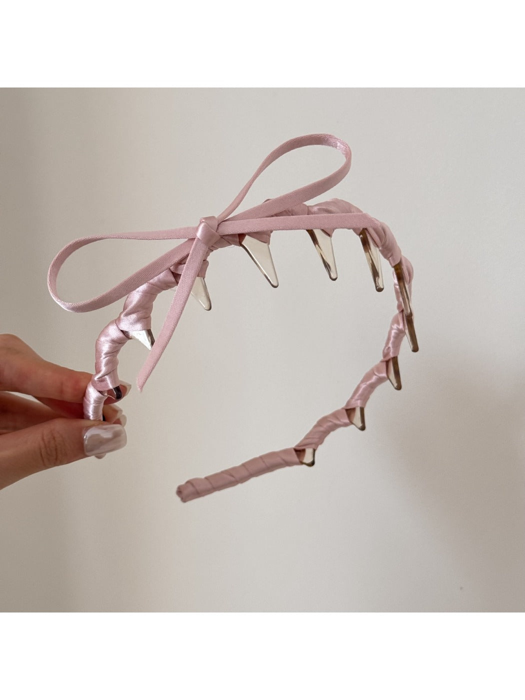 Top view of pink bow headband highlighting bow shape and size