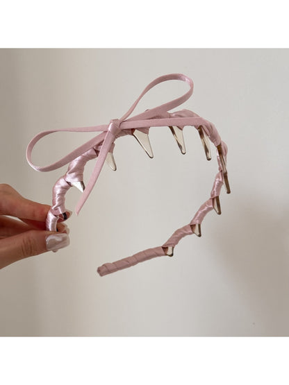 Top view of pink bow headband highlighting bow shape and size