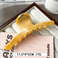 Beau large claw clip displayed next to matching hair accessories