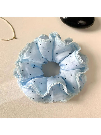 Pink polka dot scrunchie displayed on a white background