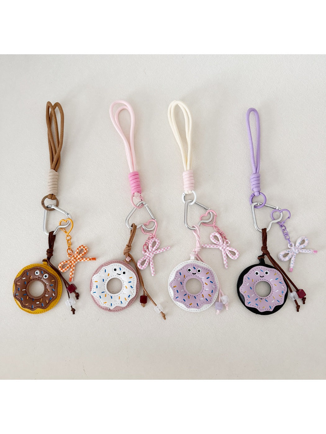 Close-up of a pink donut-shaped keychain with sprinkles and a metal keyring