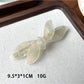 Beau bow shaped updo hair clip displayed with packaging and branding