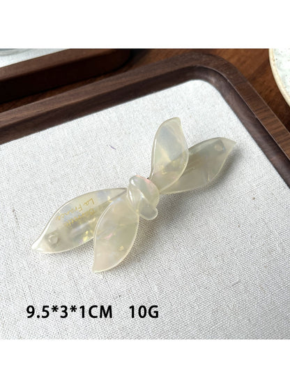 Beau bow shaped updo hair clip displayed with packaging and branding