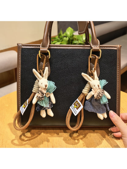 Close-up of rabbit charm keychain showing detailed facial features and ears