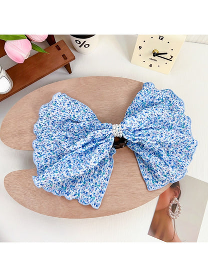 Beau Polka Dot Bow Claw Clip on white background, angled view