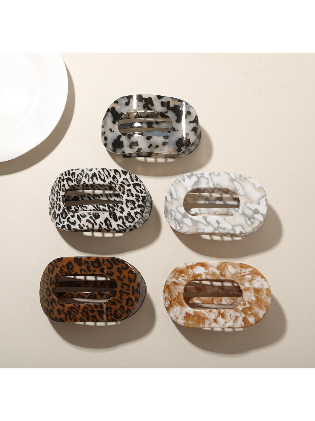 Close-up of Beau hair clip showing detailed multicolor pattern and glossy finish