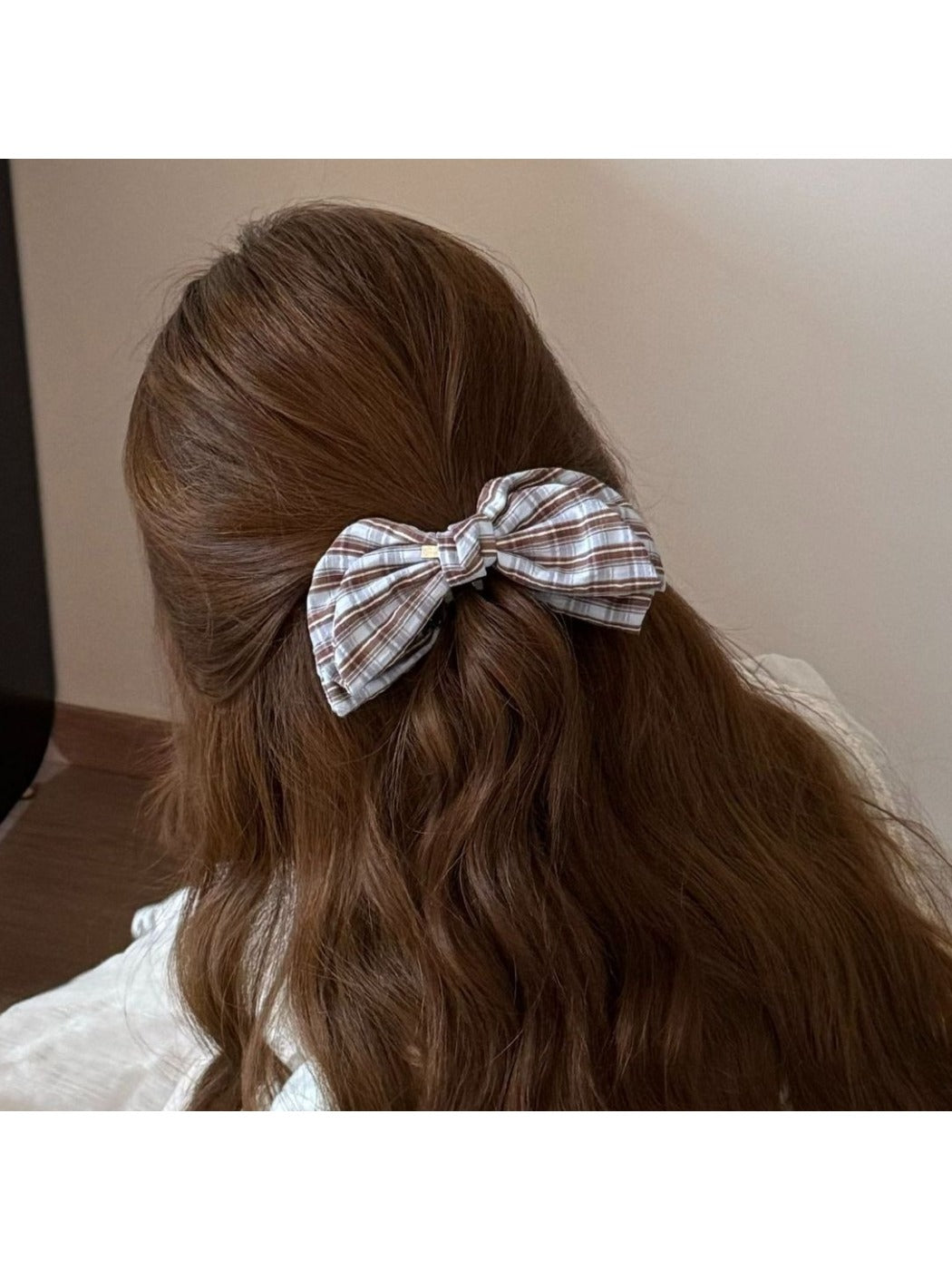 Model wearing Beau elegant bow banana clip in black, styled in long hair