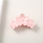 Bright flower hair clip displayed on a white background showing full shape