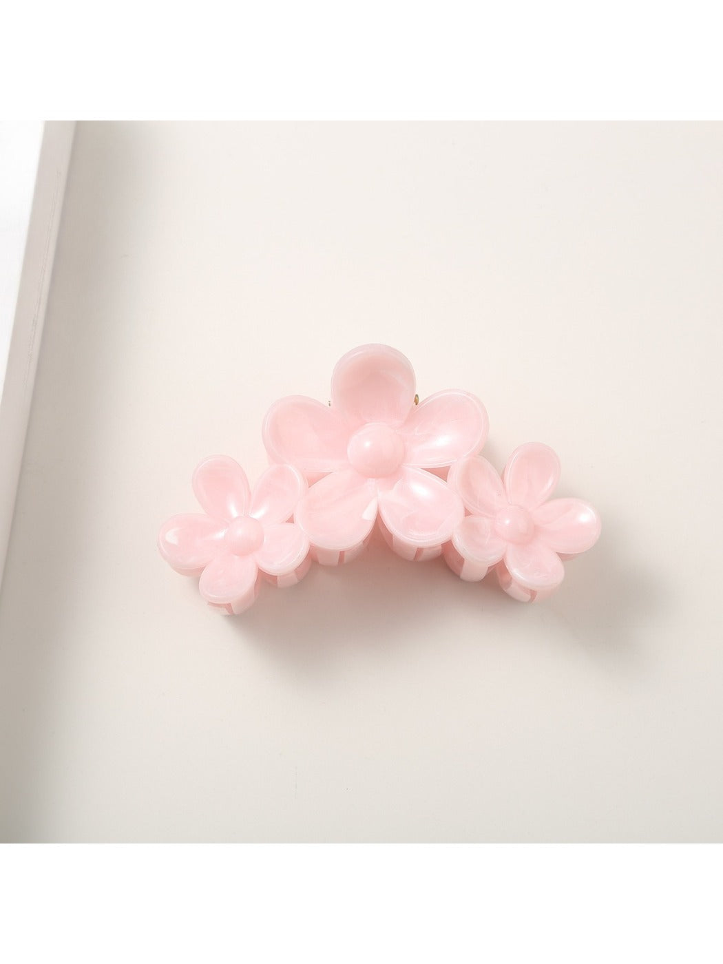 Bright flower hair clip displayed on a white background showing full shape