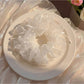 White double layer scrunchie with minimalist modern design on a plain background