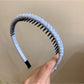 Model smiling while wearing Gifty minimalist solid color headband
