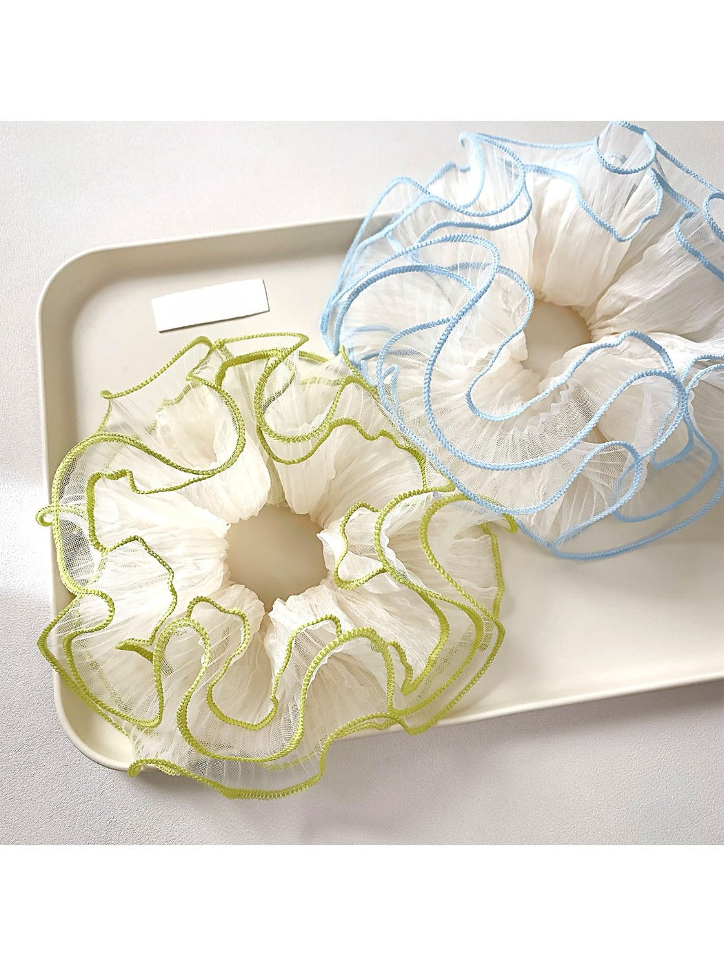 Close-up of Gifty Natural Misty Mesh Scrunchie in soft beige fabric