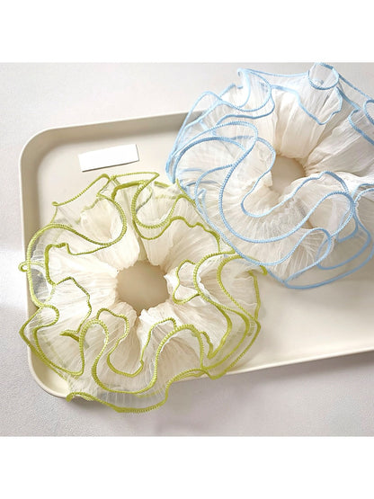 Close-up of Gifty Natural Misty Mesh Scrunchie in soft beige fabric