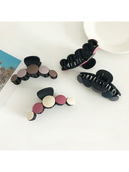 Close-up of Beau hair clip showing smooth matte finish and curved edges