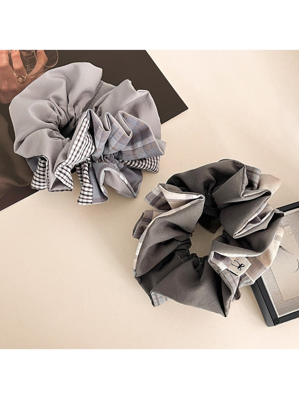 Close-up of Gifty scrunchie showing detailed plaid and patchwork fabric textures