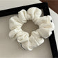 Gifty Lazy Style scrunchie laid flat, emphasizing the openwork fabric and stitching details