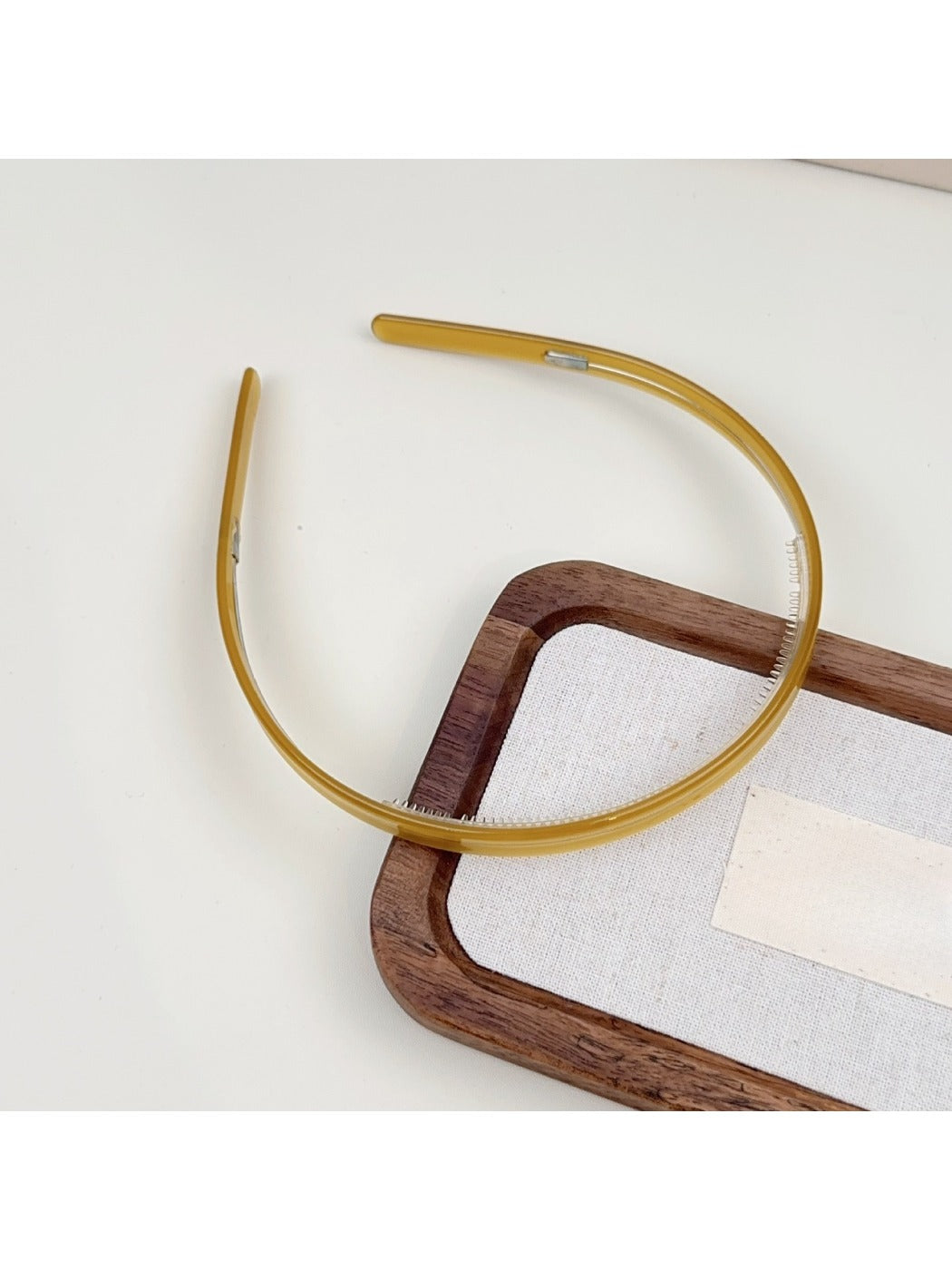 Gifty headband in pastel color placed on wooden surface