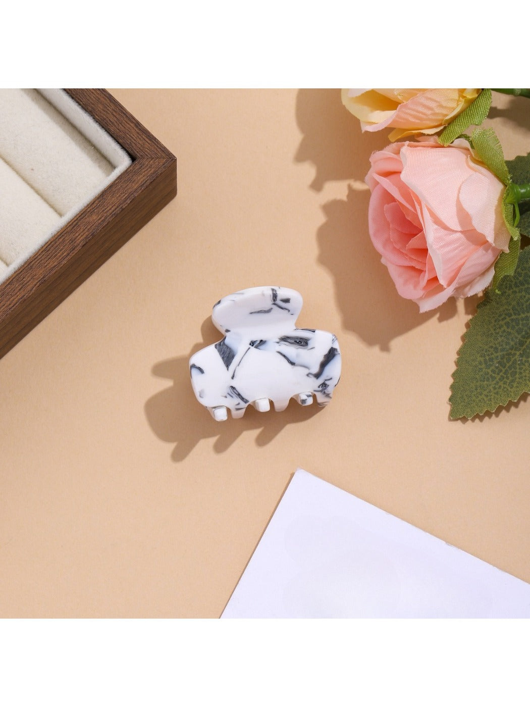 Beau vibrant acetate hair clip held in hand to show size and shape