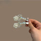 Close-up of Beau bow hair clip with rhinestones on a white background