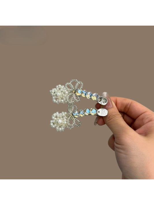 Close-up of Beau bow hair clip with rhinestones on a white background