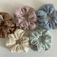 Soft chic dot cutout scrunchie in light beige fabric with small circular cutouts