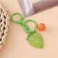 Strawberry charm keychain displayed alongside other colorful keychains