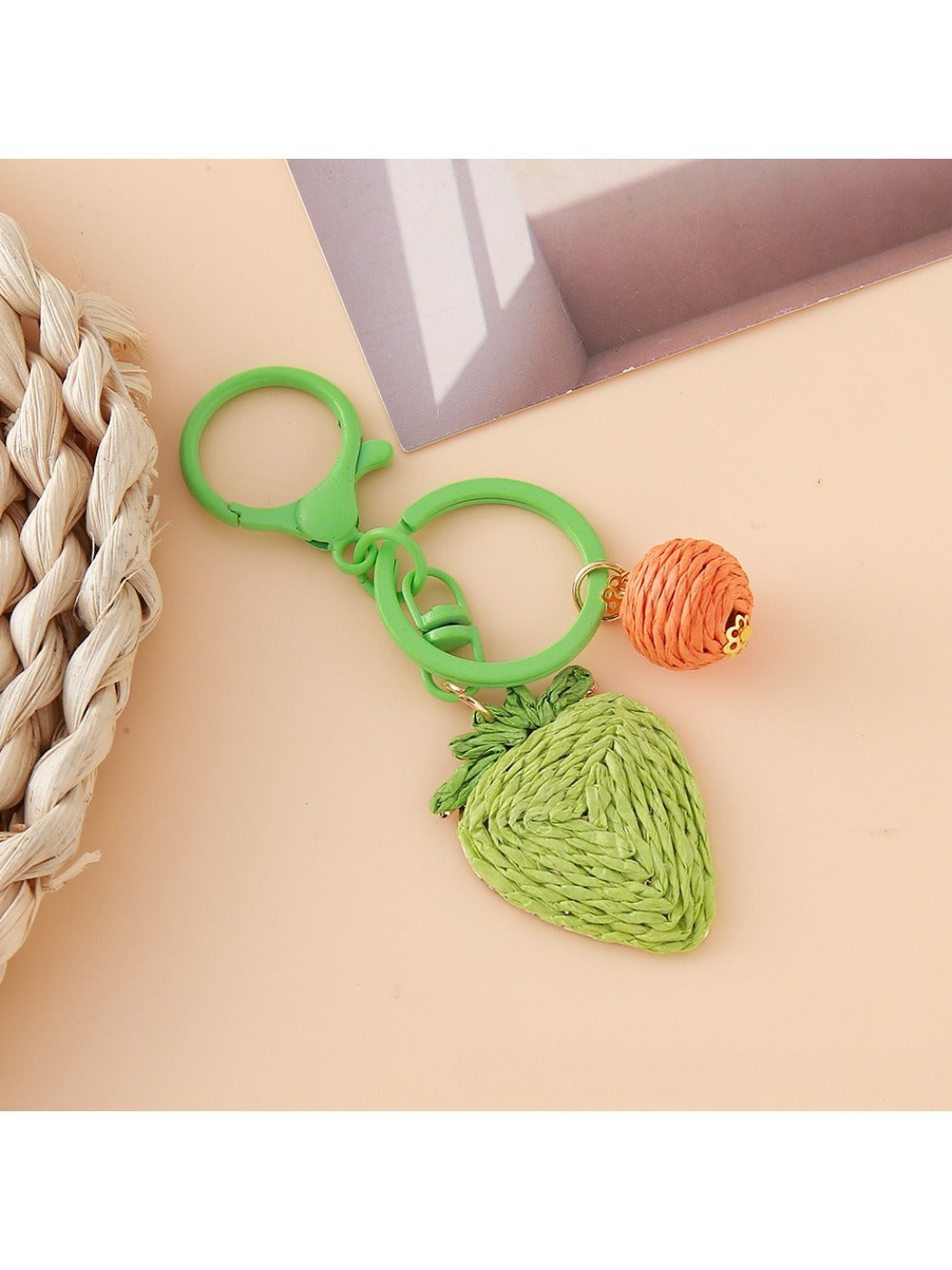 Strawberry charm keychain displayed alongside other colorful keychains