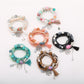 Lovra bracelet with tree-shaped tassel pendant and multicolored beads on a white background