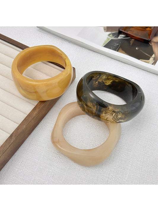 Lovra trendy wide bangle bracelet with irregular shape in polished silver finish