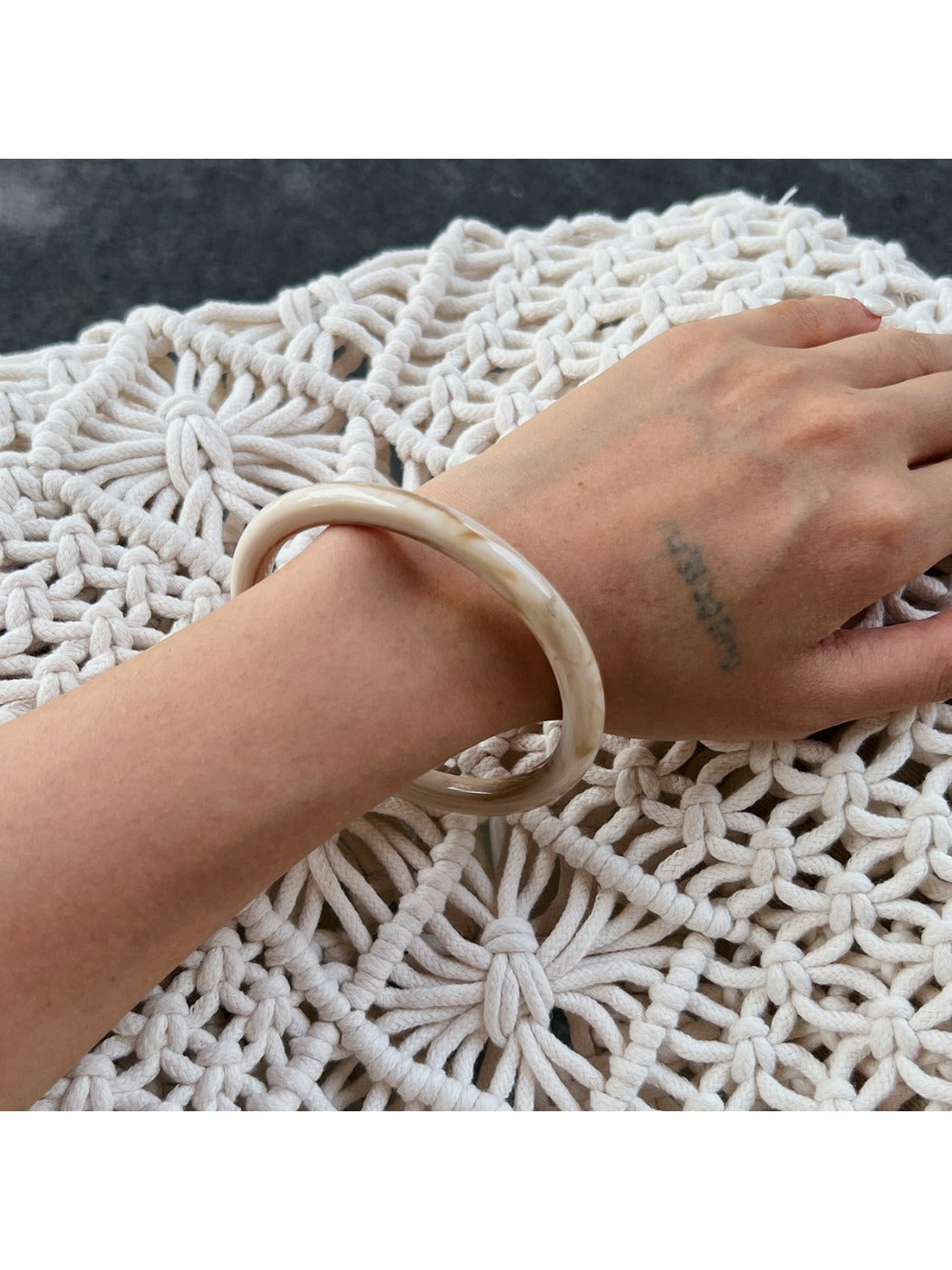 Stacked Lovra vintage ombre bangle bracelets showing color variation