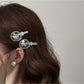 Side view of the Beau hair clip showing the curved gold clip mechanism