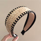 Bohemian wide minimalist headband styled with casual outfit on a wooden surface