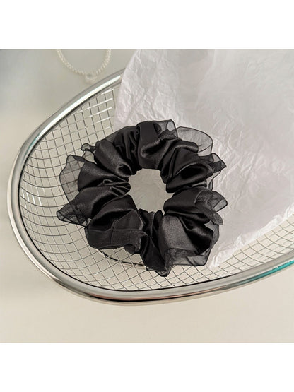 Model wearing Gifty satin tulle ruffle trim scrunchie in hair