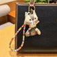 Vintage cat charm keychain with antique bronze finish on a white background