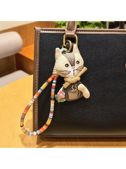 Vintage cat charm keychain with antique bronze finish on a white background