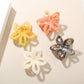 Close-up of Beau openwork flower hair clip showing vibrant multicolor petals