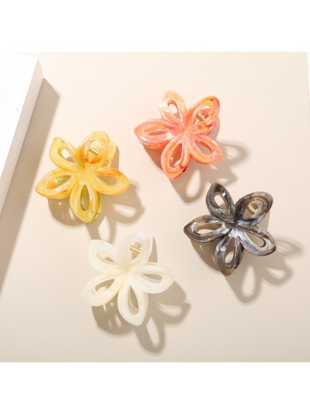Close-up of Beau openwork flower hair clip showing vibrant multicolor petals