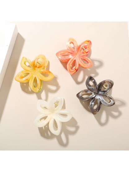 Close-up of Beau openwork flower hair clip showing vibrant multicolor petals