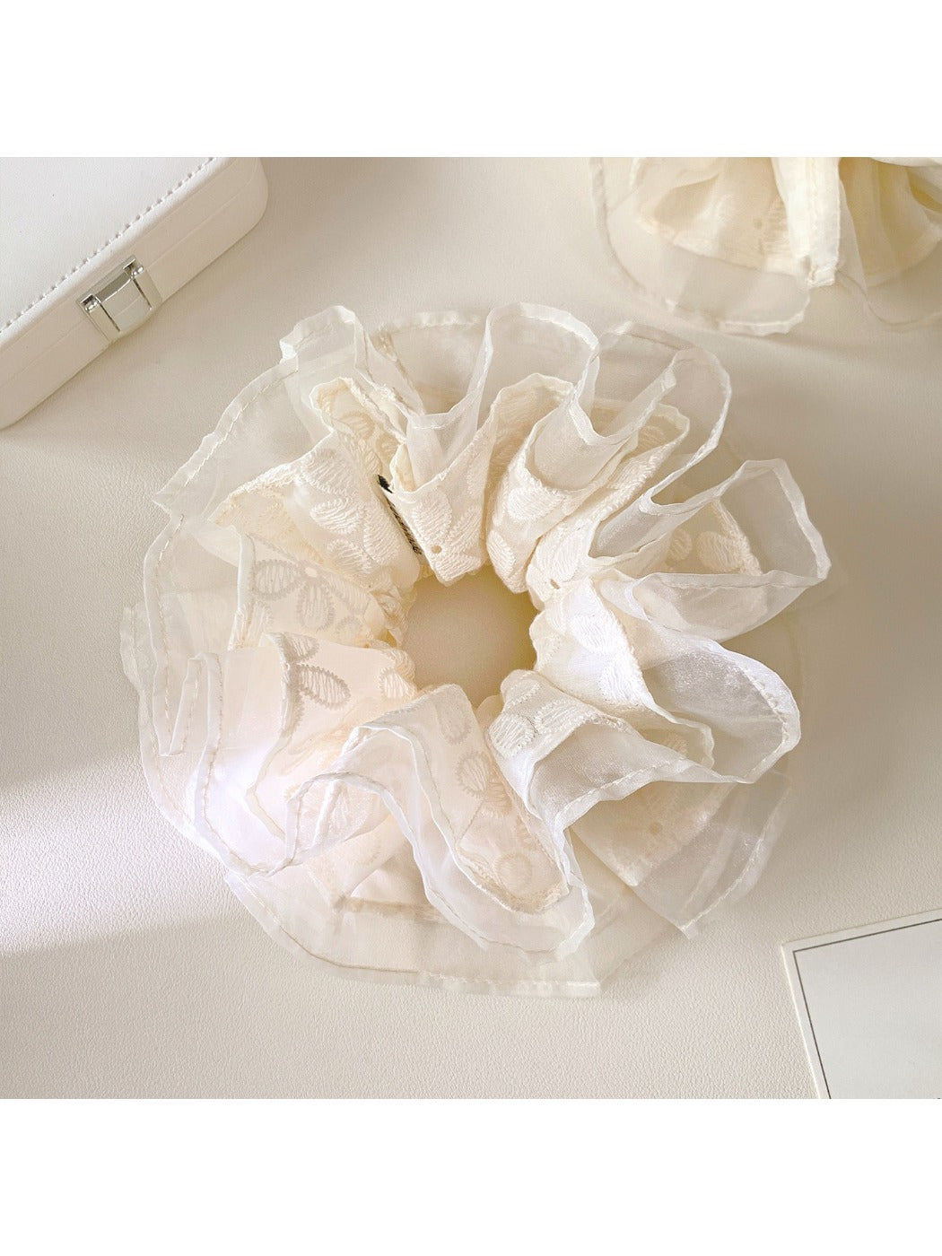 White lace multi-layer scrunchie displayed flat highlighting texture and layers