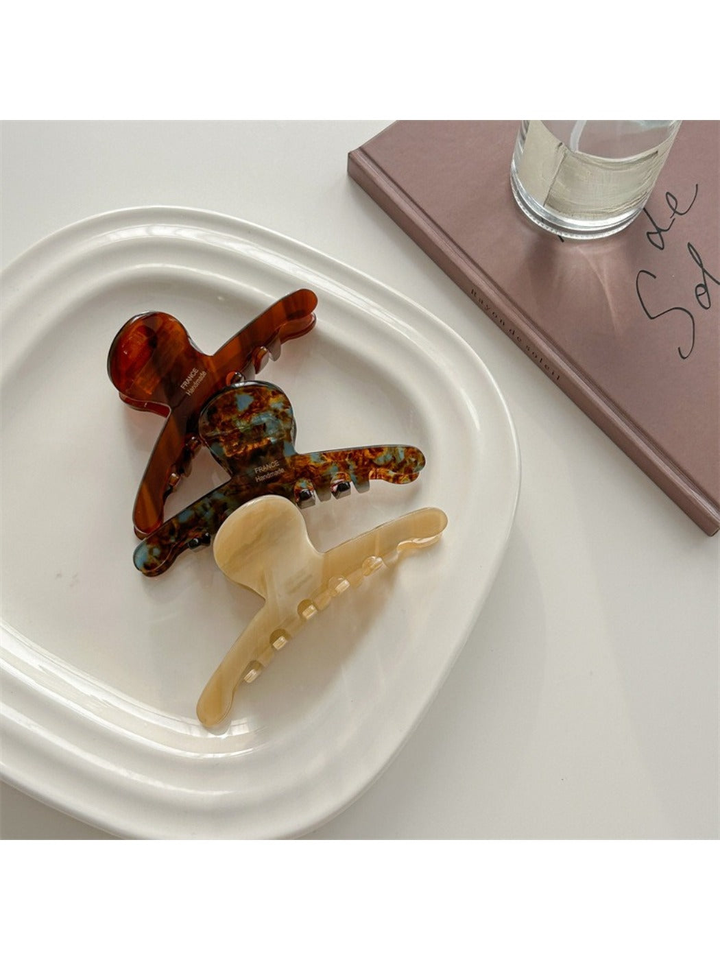Close-up of Beau acetate claw clip showing glossy finish and curved design