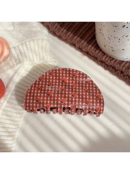 Beau plaid hair claw clip held in hand showing size and pattern