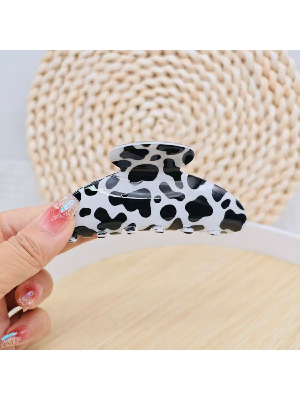 Beau leopard print claw clip displayed on a wooden surface